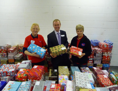 Tim checking the shoeboxes with volunteers. From left to right Mrs Patricia Robin (Polly), Tim, and Mrs Rosemary Webster.