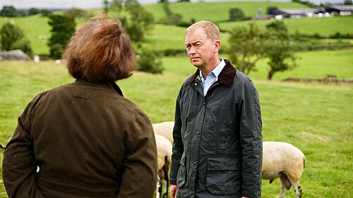Tim listening to a local farmer