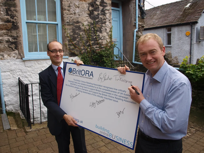 Image courtesy of Tim Farron MP Tim Farron MP signing the BritORA broadband petition with Adrian Quine.
