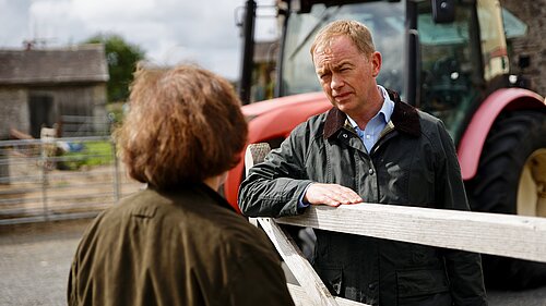 Tim listening to a local farmer